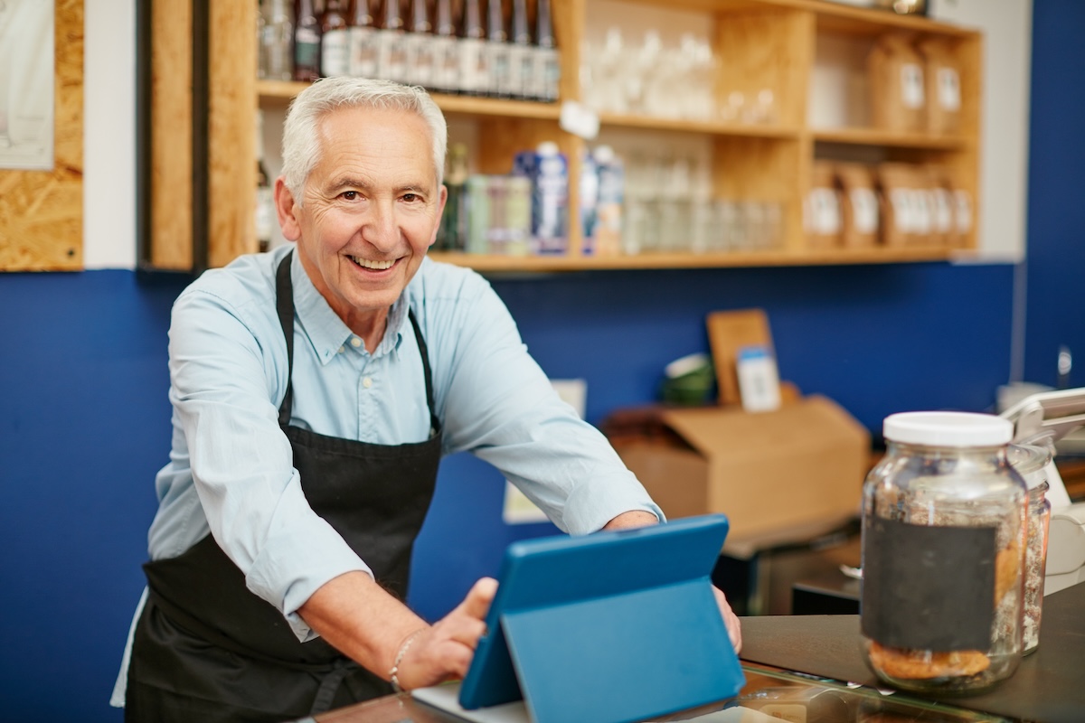Retirees are opting to go back to work to stay active and engaged; retiree working in a store.